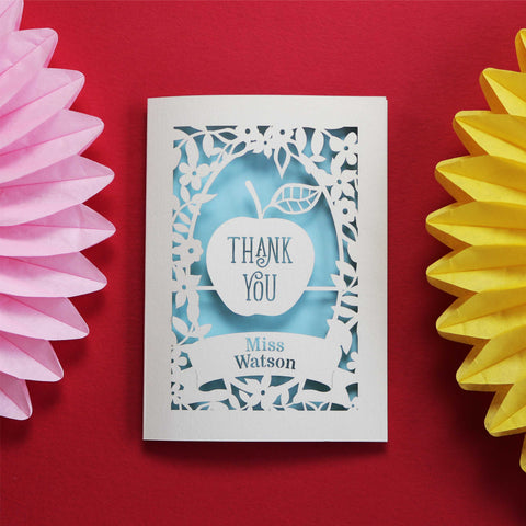 A Thank You card for a teacher, showing an apple . Cream cards with pale blue background. Personalise with teacher's name. - A5 / Light Blue