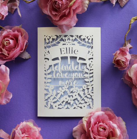 A laser cut Valentines card that says "I definitely love you more" - A5 / Lilac