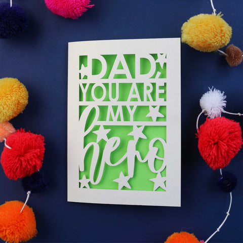 A cream laser cut Father's Day card with the words "DAD, YOU ARE MY HERO" surrounded by stars.  - A6 (small) / Bright Green