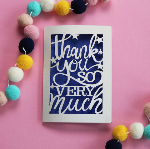 A laser cut thank you card that reads "Thank you so very much" with stars around the text