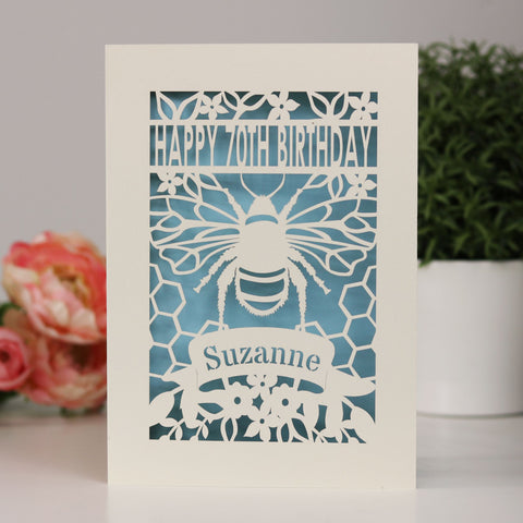 Cream and pale blue personalised papercut bee design . Has Happy 70th birthday shown across the top and personalised in the banner. - A5 (large) / Light Blue