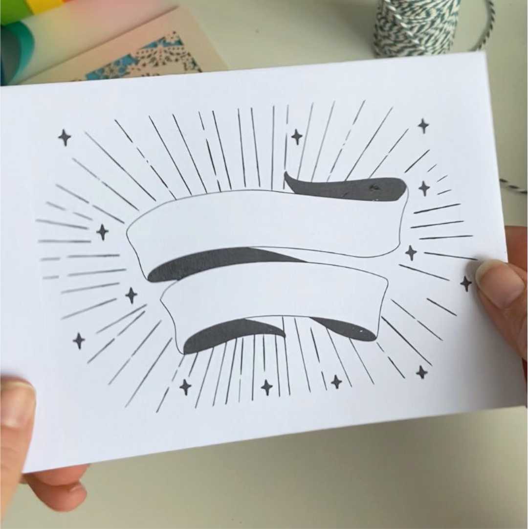 a printable envelope design of a banner and starbursts