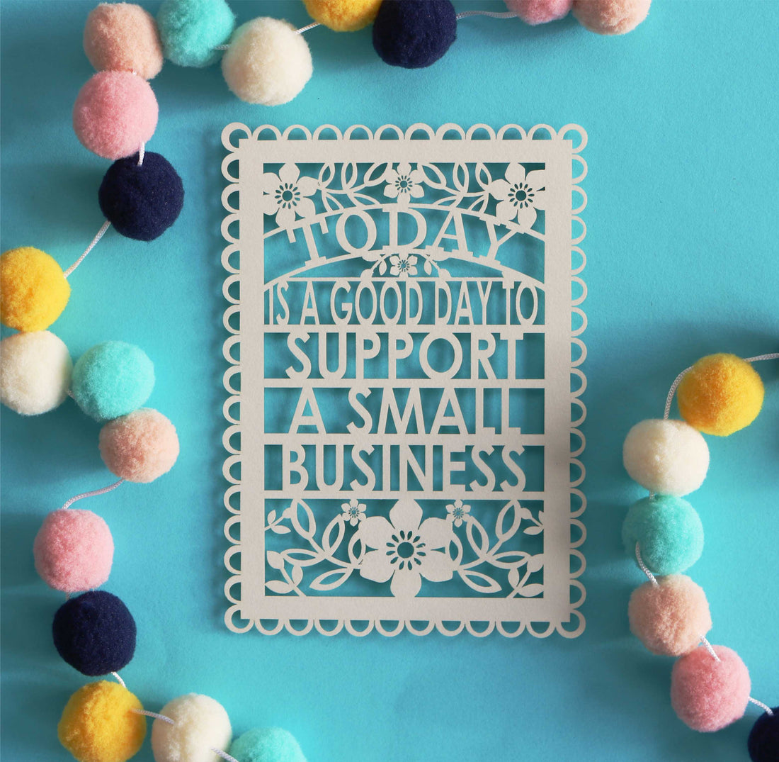 A laser cut postcard that says 'today is a good day to support small business'