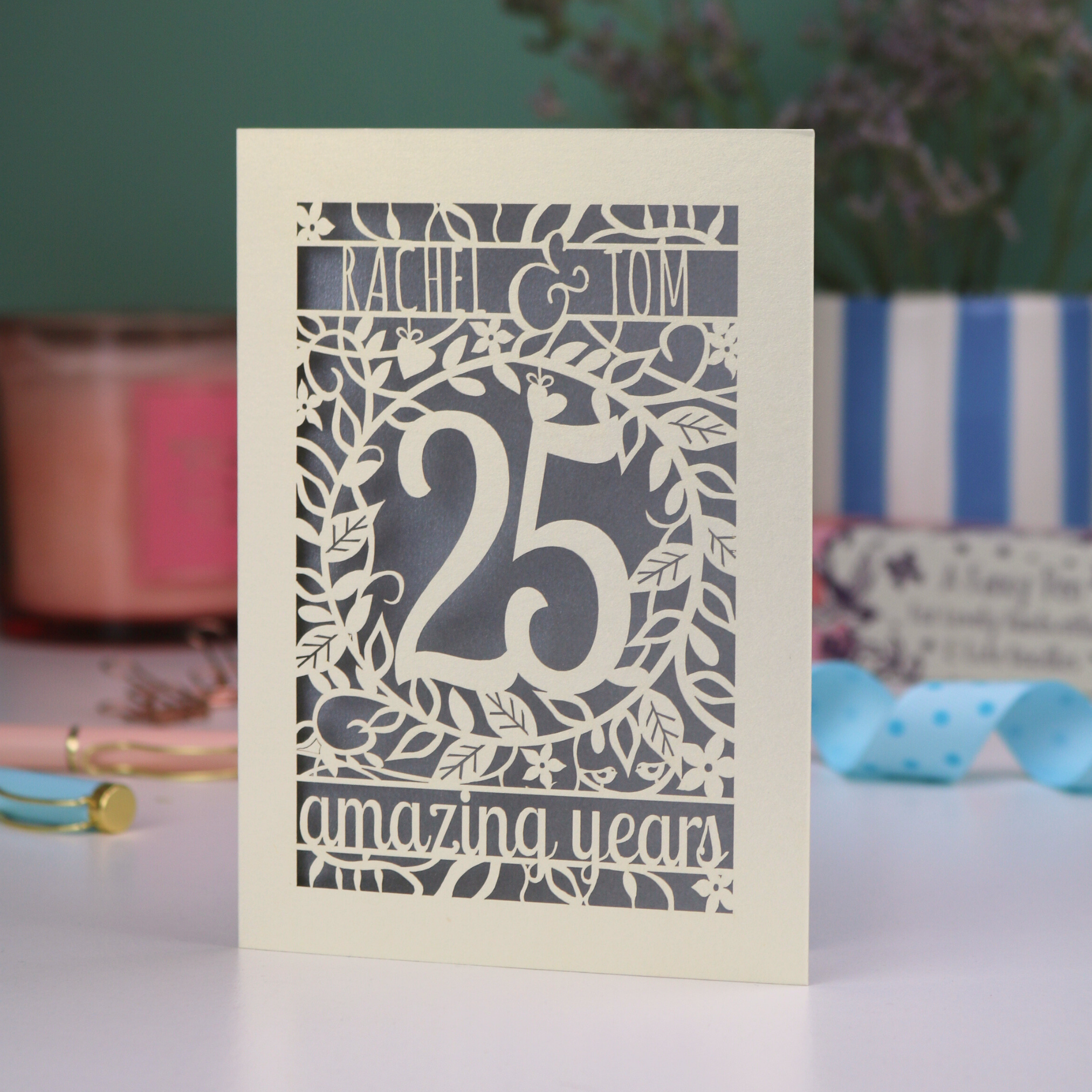 A laser cut 25th anniversary card in cream and silver