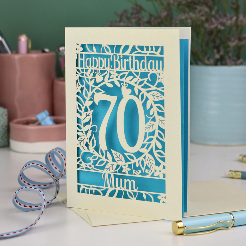 A 70th birthday card laser cut and personalised with recipient's name. Card has a number 70 and woodland themed cut out illustrations.