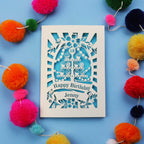 Laser-cut 18th birthday card with colourful pom-poms on a blue background
