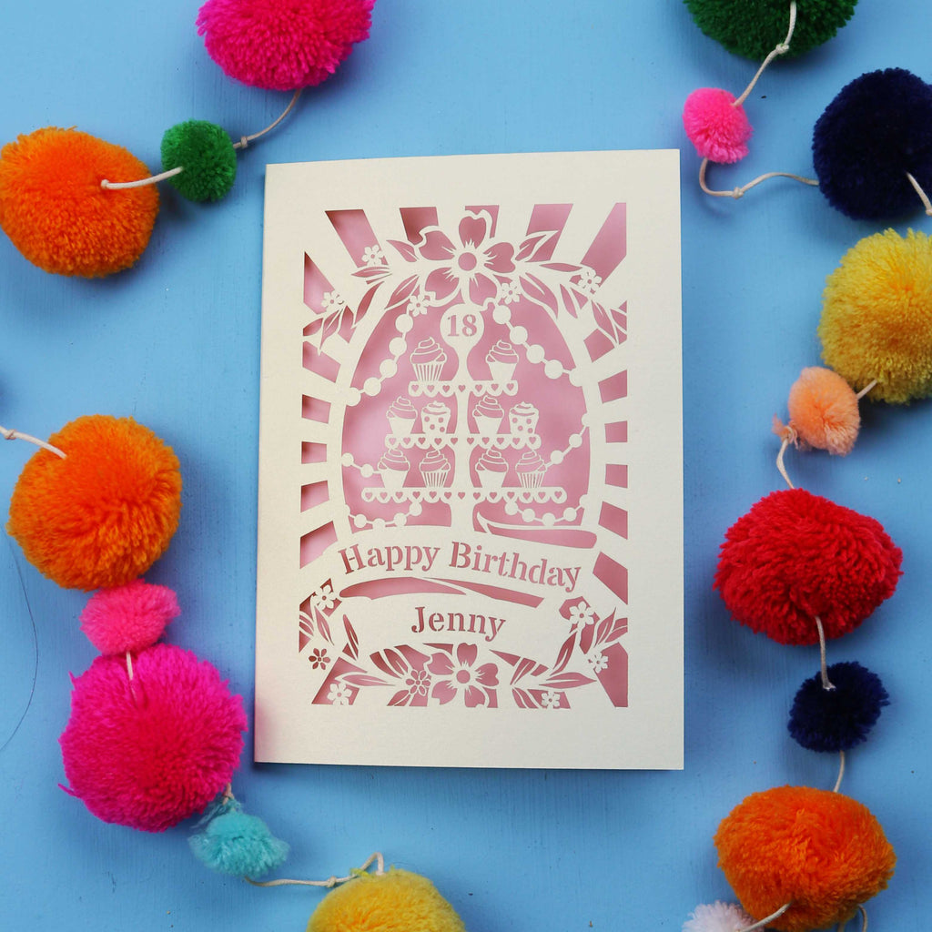 Laser-cut 18th birthday card with colourful pom-poms on a blue background