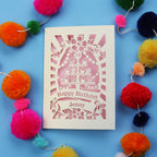 Laser-cut 18th birthday card with colourful pom-poms on a blue background