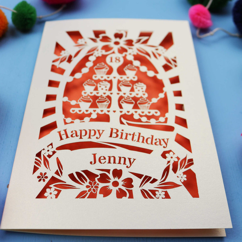 Laser-cut 18th birthday card with colourful pom-poms on a blue background