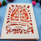 Laser-cut 18th birthday card with colourful pom-poms on a blue background