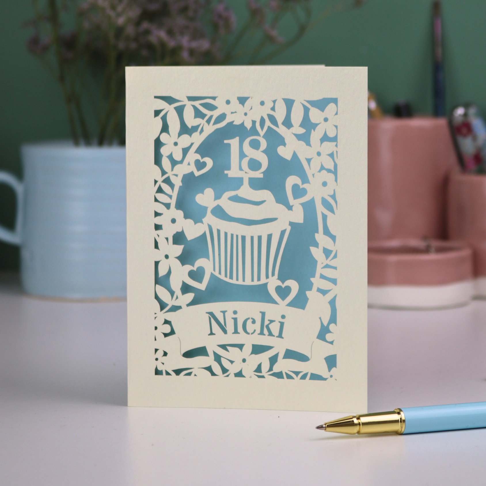 Personalised cut out 18th birthday card with cupcake design and '18 Nicki' text on a light background.