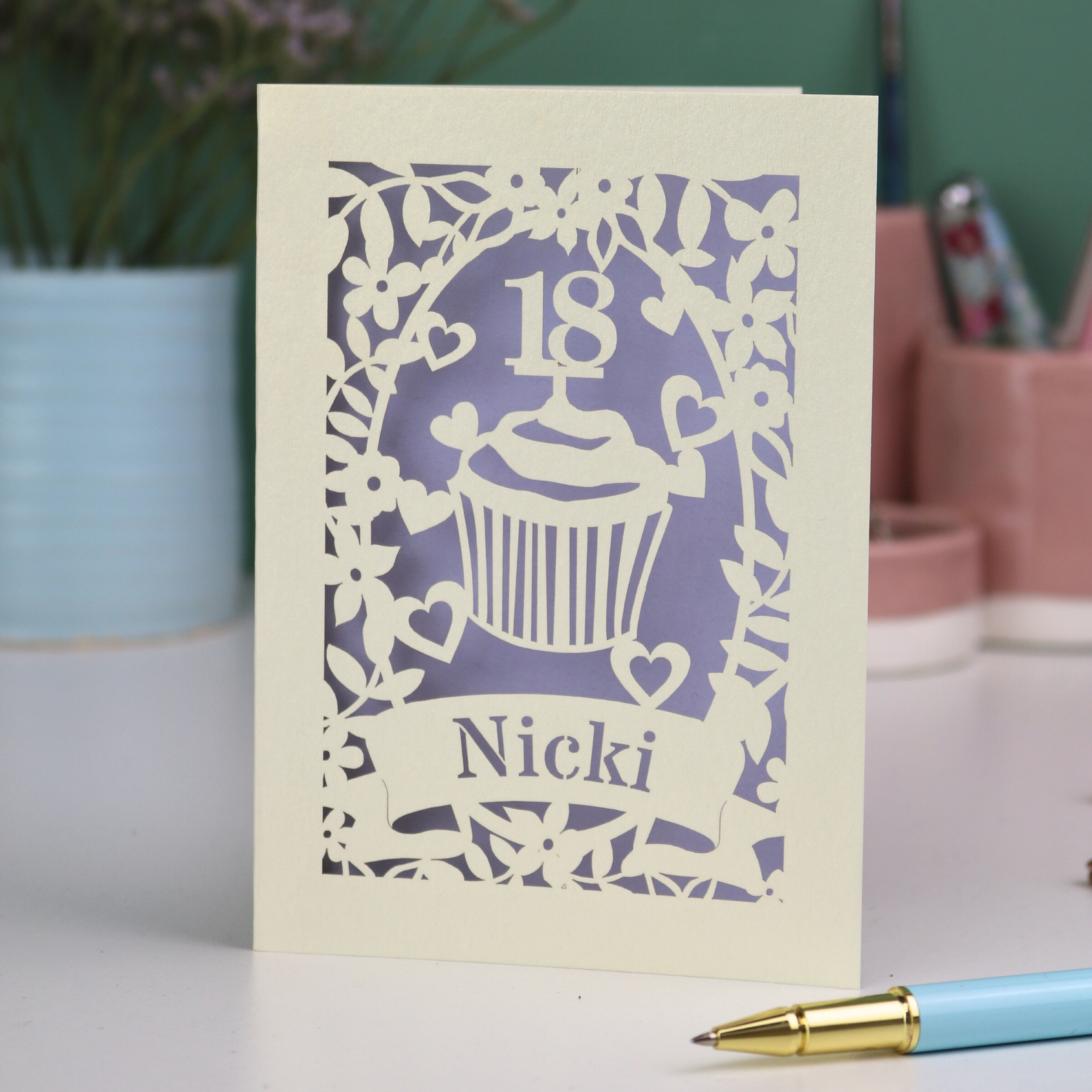 Personalised laser cut 18th birthday card with cupcake design and '18 Nicki' text on a light background.
