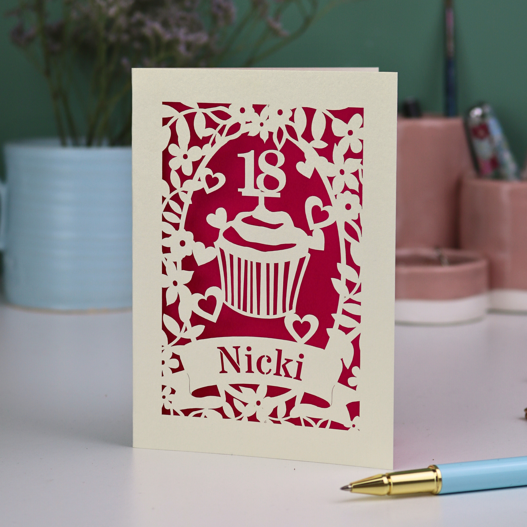 Personalised laser cut 18th birthday card with cupcake design and '18 Nicki' text on a light background.