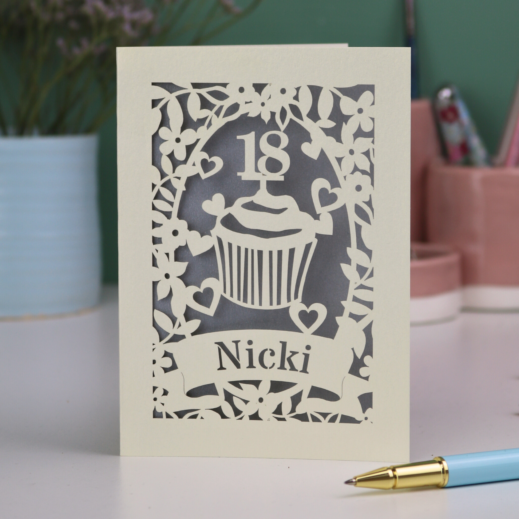 Personalised laser cut 18th birthday card with cupcake design and '18 Nicki' text on a light background.