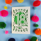 Decorative 18th birthday card with '18' and 'Olivia' on a blue background with colourful pom-poms.