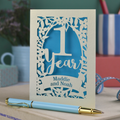 1st Wedding anniversary Card with '1 Year' and 'Maddie and Noah' text, accompanied by a blue pen on a desk.