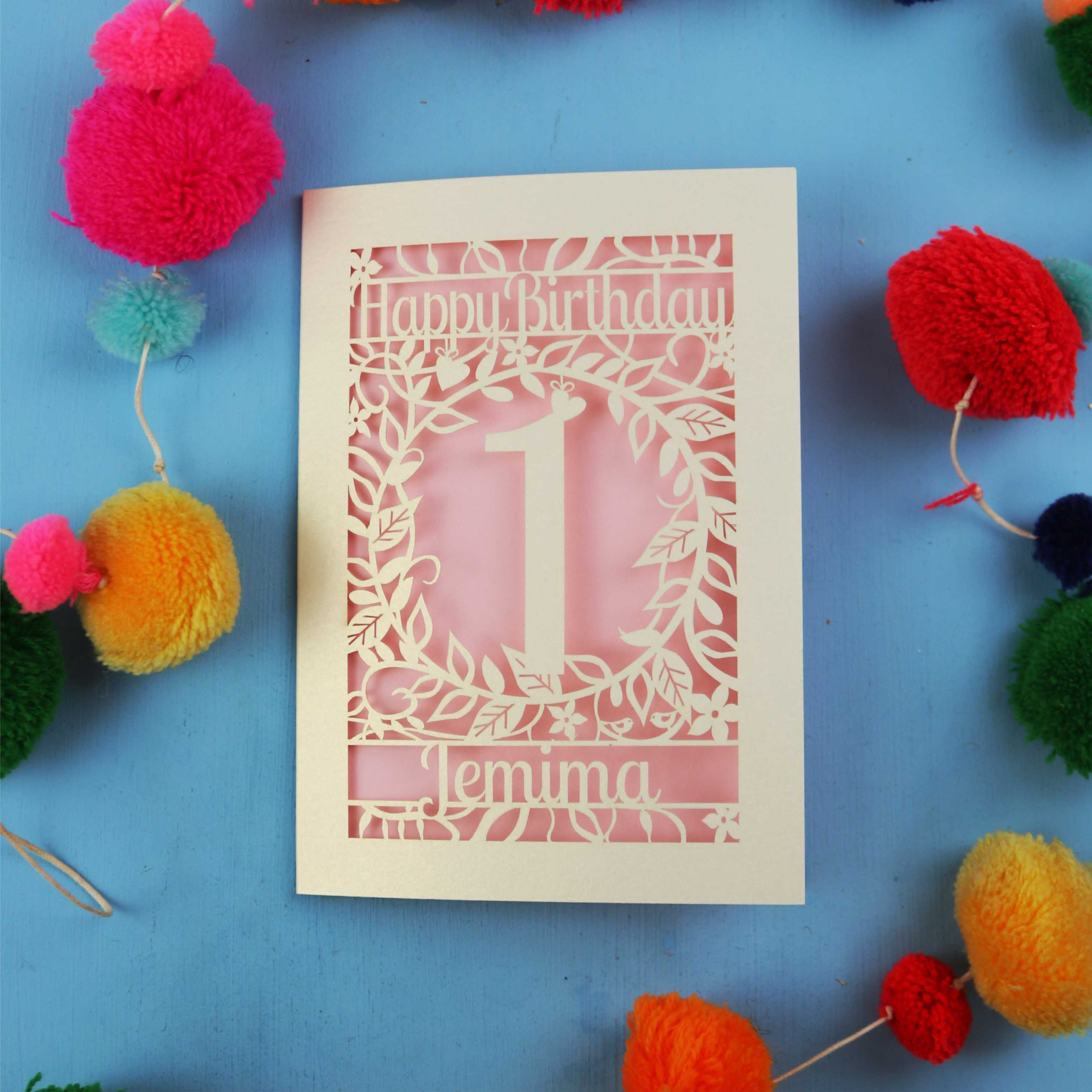 Personalised 1st birthday card with decorative elements on a blue background