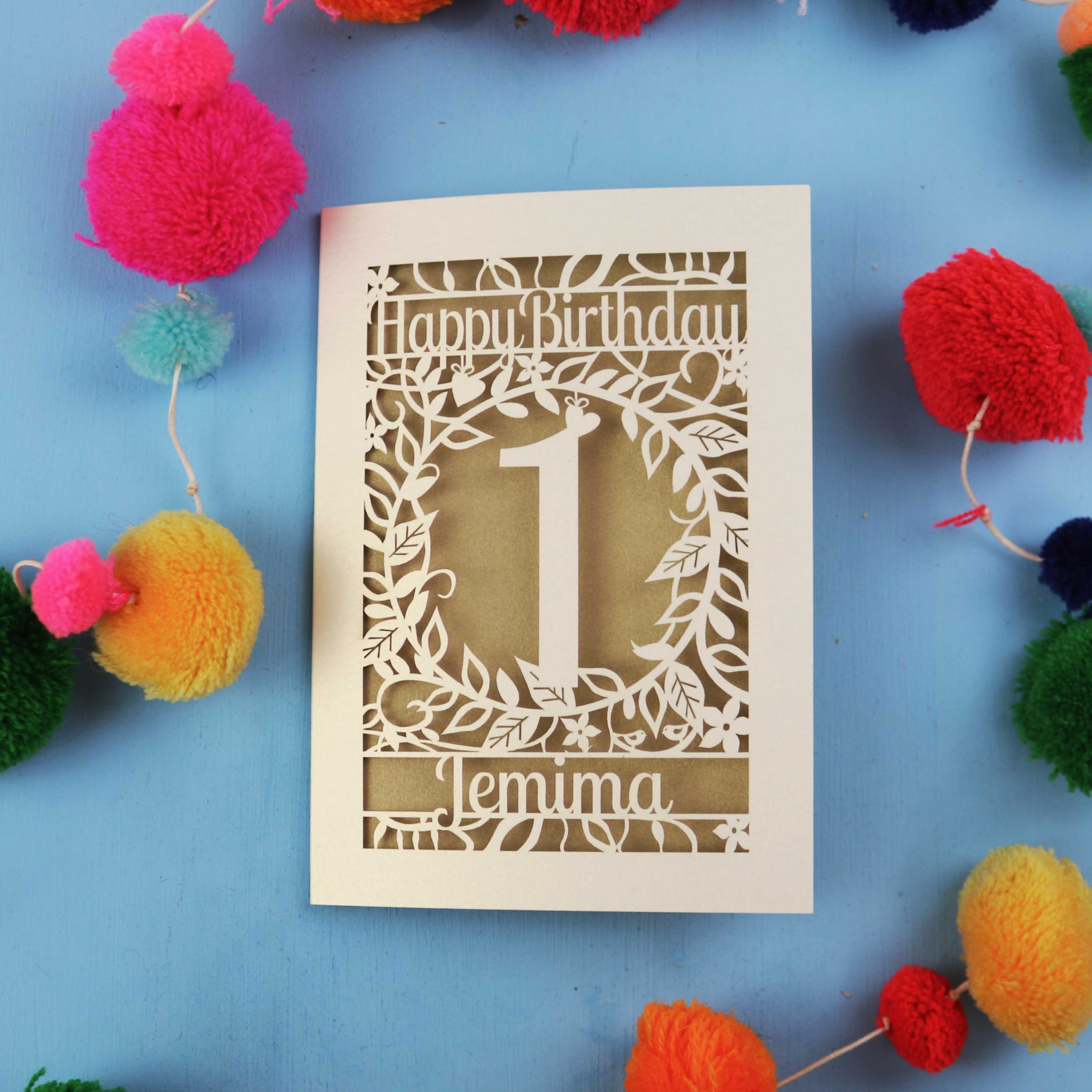 Personalised 1st birthday card with decorative elements on a blue background