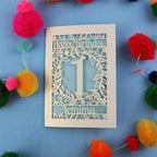 Personalised 1st birthday card with decorative elements on a blue background