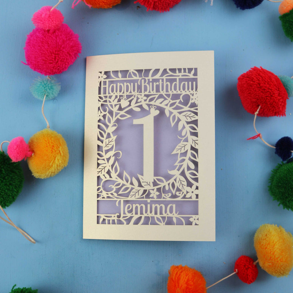 Personalised 1st birthday card with decorative elements on a blue background