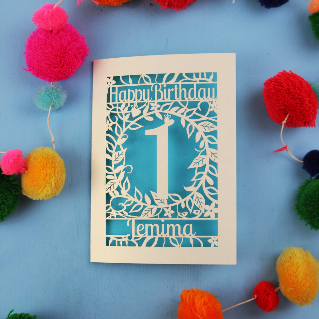 Personalised 1st birthday card with decorative elements on a blue background