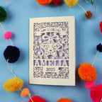 A laser cut baby's first Christmas card with intricate star design and personalised with baby's name and the year