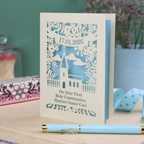 A personalised laser cut 'On Your 1st Holy Communion' card with cut out church design, floral border, the date and name in cut out stencil font.