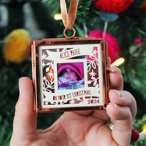 A personalised paper cut first Christmas decoration with a photograph