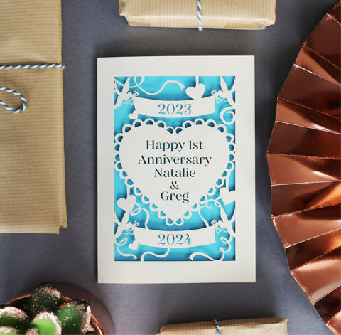 A laser cut anniversary card personalised with years and first names of the recipient.  - 