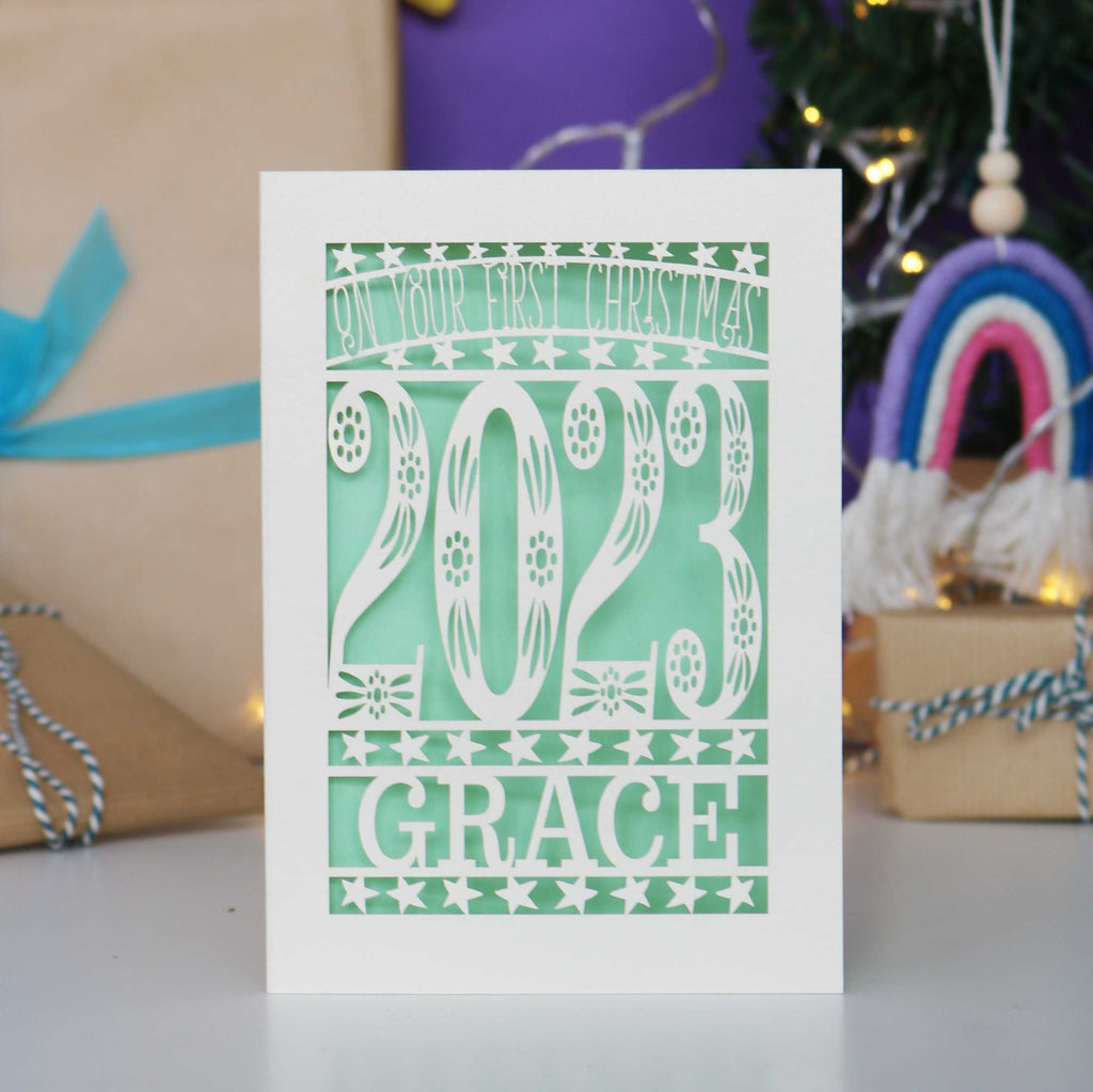 A personalised 1st Christmas cards cut from cream  card with a pretty light green insert.