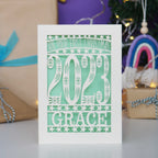 A personalised 1st Christmas cards cut from cream  card with a pretty light green insert.
