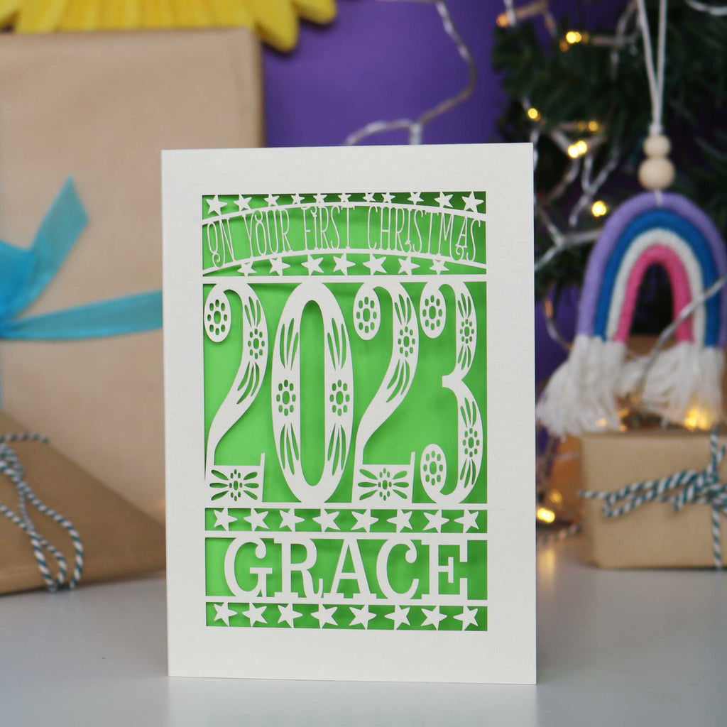 Personalised baby's first Christmas card in Cream and green.