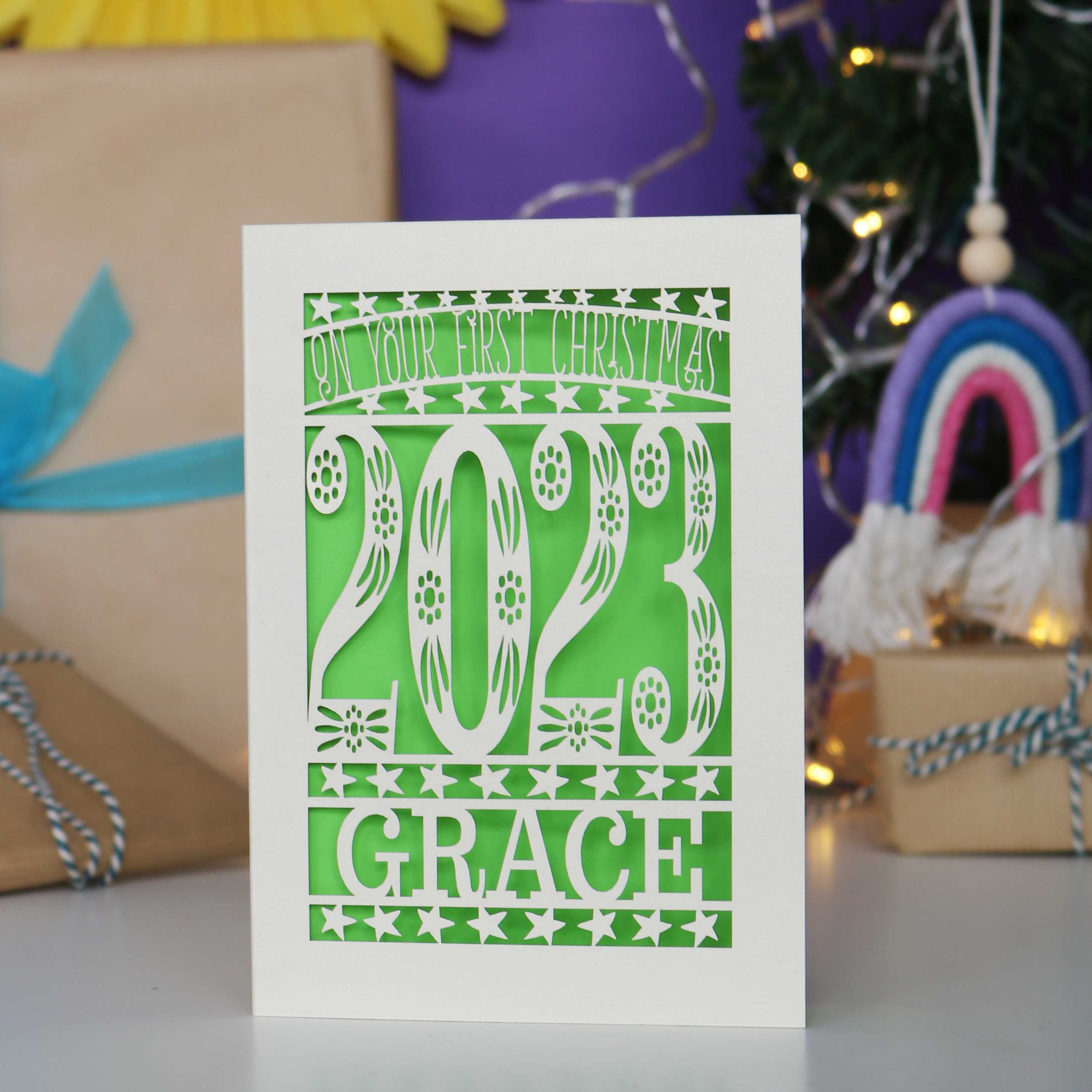 Personalised baby's first Christmas card in Cream and green.