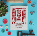 A personalised laser cut Christmas card that says "Names, Happy 1st Christmas in your new home"
