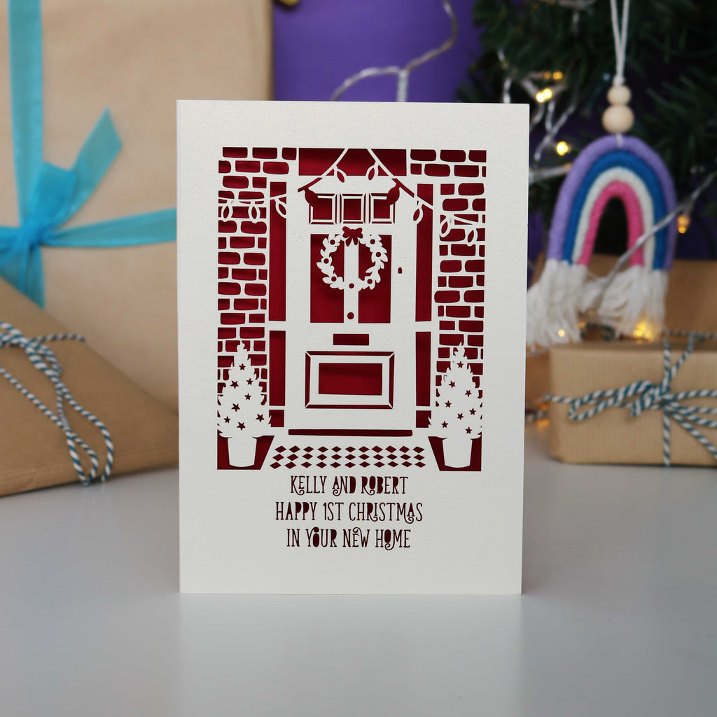 A Happy First Christmas in your New Home laser cut Christmas card, personalised with their names.