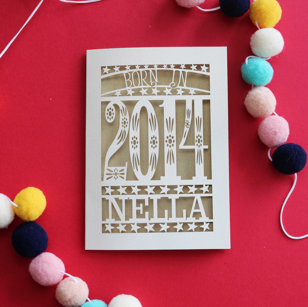 A cut out tenth birthday card, personalised with a name and the words, "Born in 2014"