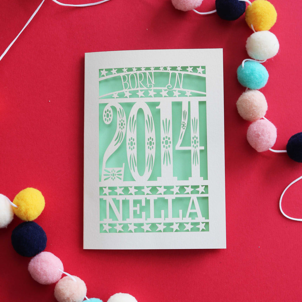 A paper cut tenth birthday card, personalised with a name and the words, "Born in 2014"