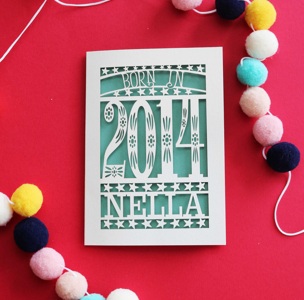 A laser cut child's birthday card, personalised with a name and the words, "Born in 2014"
