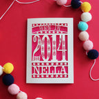 A laser cut kids' birthday card, personalised with a name and the words, "Born in 2014"