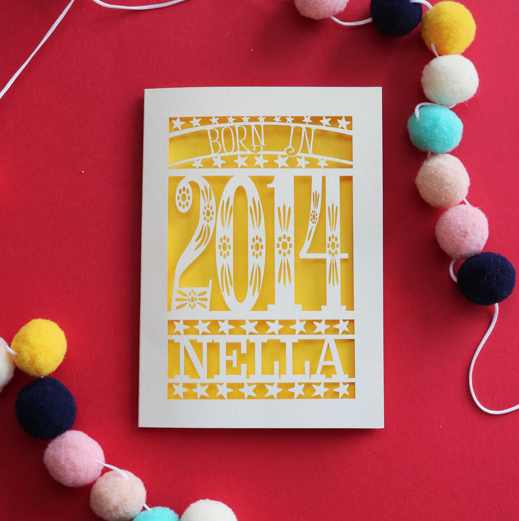 A laser cut birthday card for kids, personalised with a name and the words, "Born in 2014"