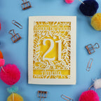 A Laser Cut 21st Birthday card with 'Happy Birthday' and age '21' on a blue background with decorative items.
