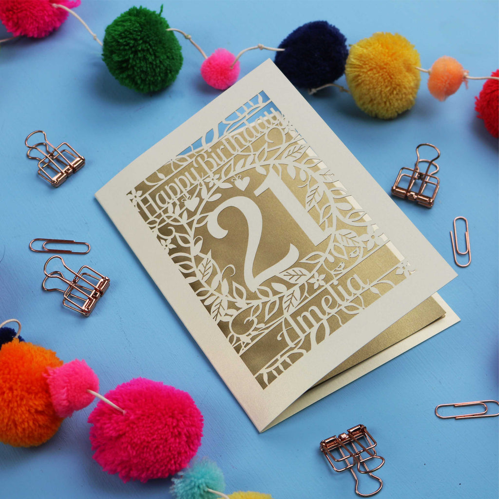 A Laser Cut 21st Birthday card with 'Happy Birthday' and age '21' on a blue background with decorative items.