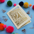 A Laser Cut 21st Birthday card with 'Happy Birthday' and age '21' on a blue background with decorative items.