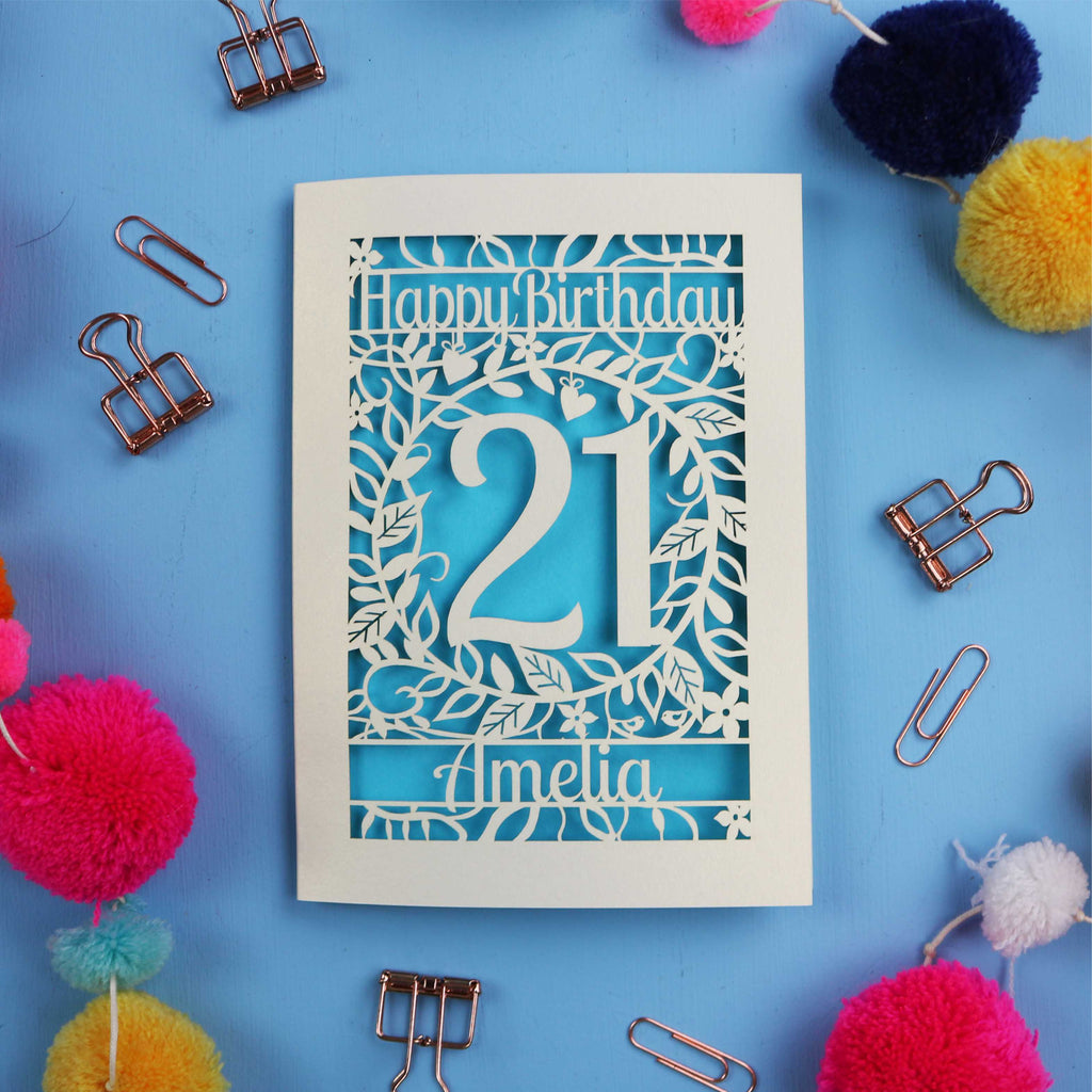 A Laser Cut 21st Birthday card with 'Happy Birthday' and age '21' on a blue background with decorative items.