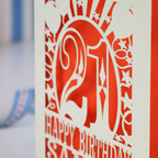  A close up photo of a laser cut 21st birthday card with 'Happy Birthday Sammy'