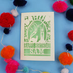 Personalized 21st birthday card with colourful pom-poms on a blue background