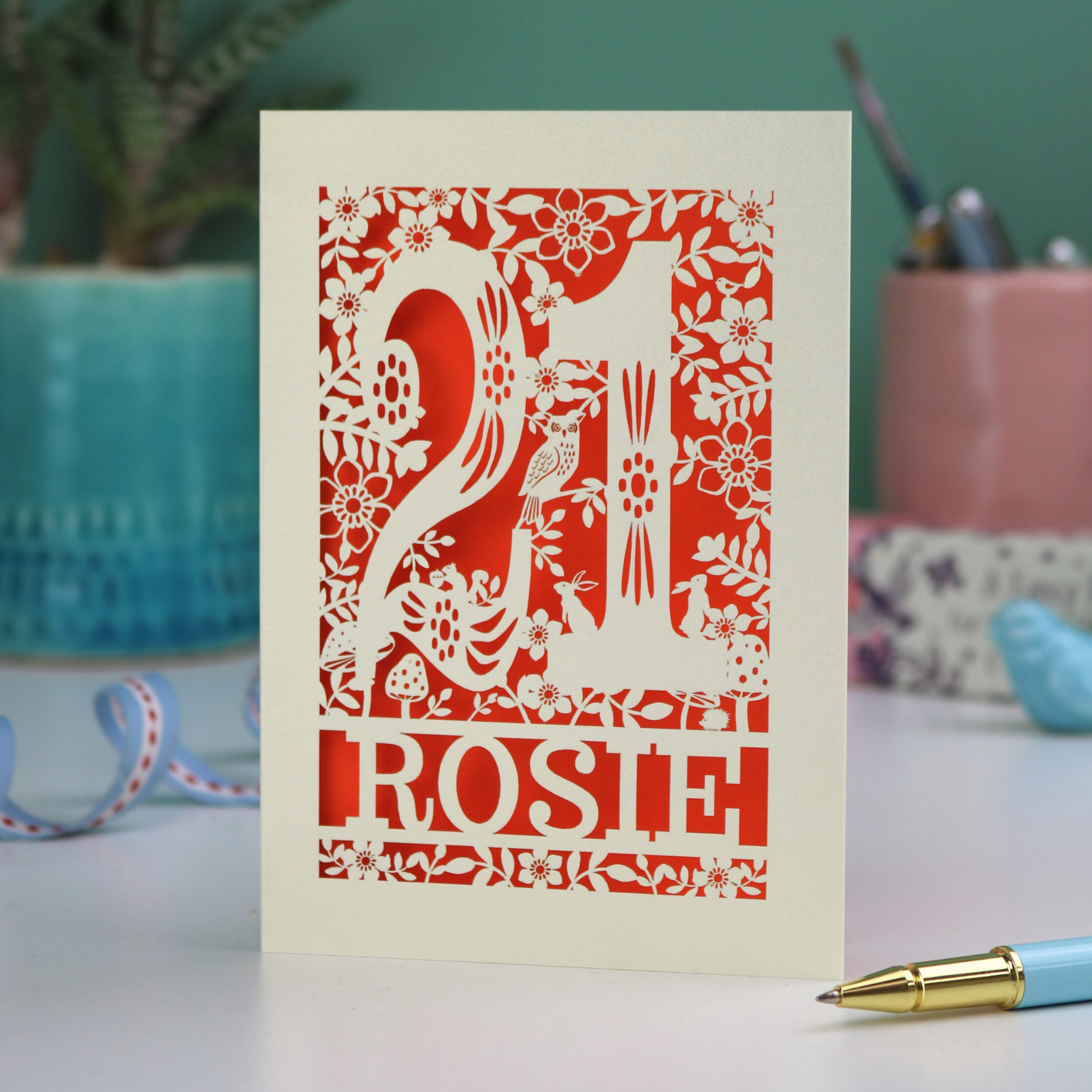 A laser cut 21st birthday card, personalised with the name "Rosie", with the number 21 in the centre and woodland theme design