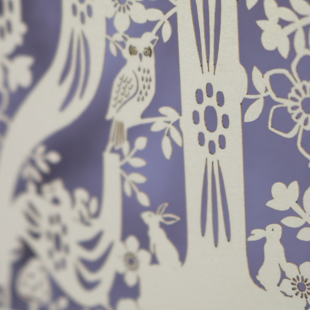 Close up photo of laser cut 21st birthday card, showing a tiny laser cut owl and rabbits