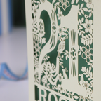 A laser cut 21st birthday card, personalised with the name "Rosie", with the number 21 in the centre and woodland theme design