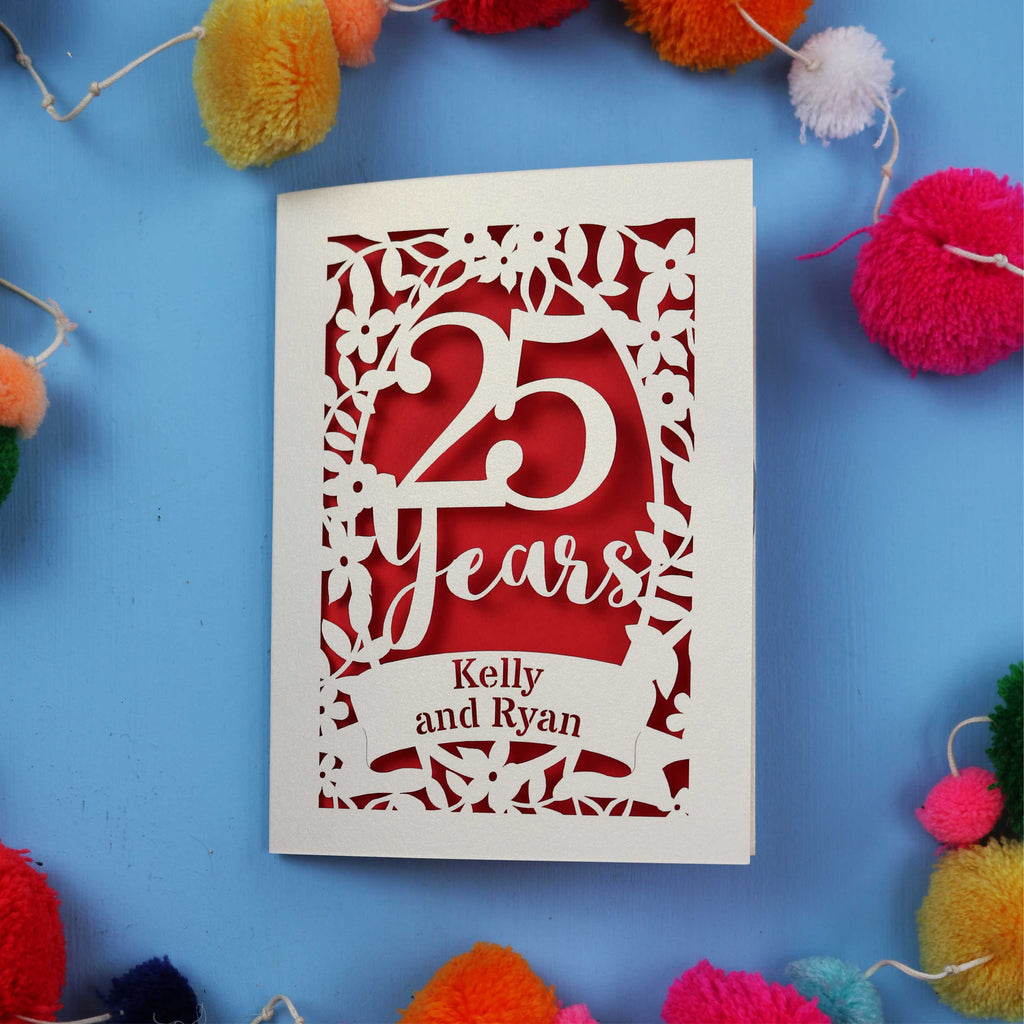 Silver Wedding Anniversary Card with '25 Years' and 'Kelly and Ryan' text on a blue background with colourful pom-poms.